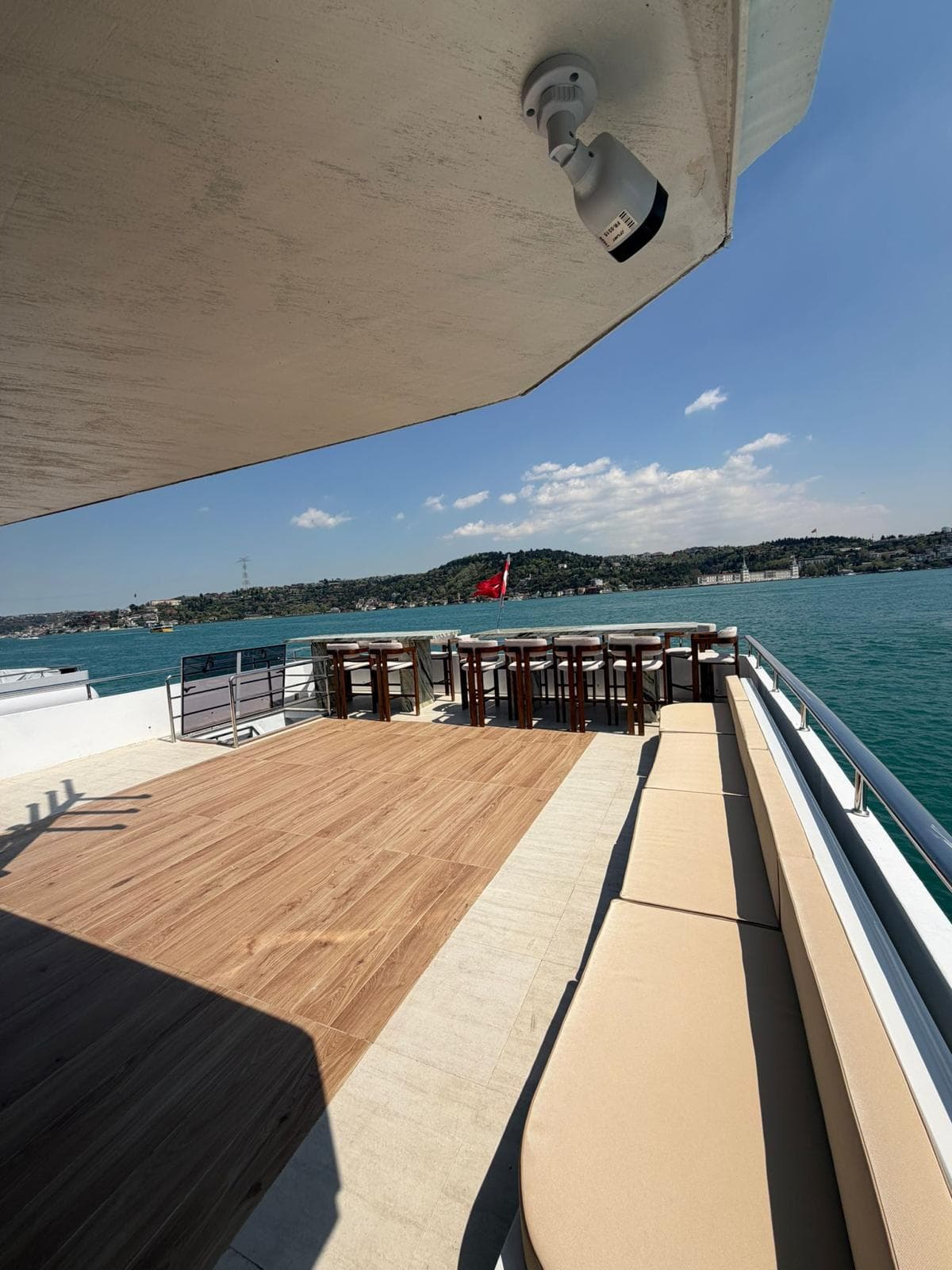 A larger event-deck yacht in the Vesper fleet cruising the Bosphorus at sunset, Istanbul